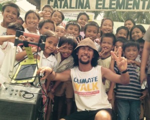 School children from Catalina Elementary School strike a pose with Greenpeace's Albert Lozada and his solar charging station.