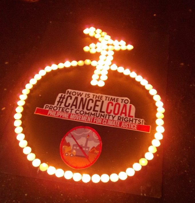 Iligan: Community leaders campaigning to protect Panguil Bay in Iligan from three coal fired power plant projects that threaten to endanger the health and livelihood of the residents along its coast, light candles to call for cancelation of coal projects.