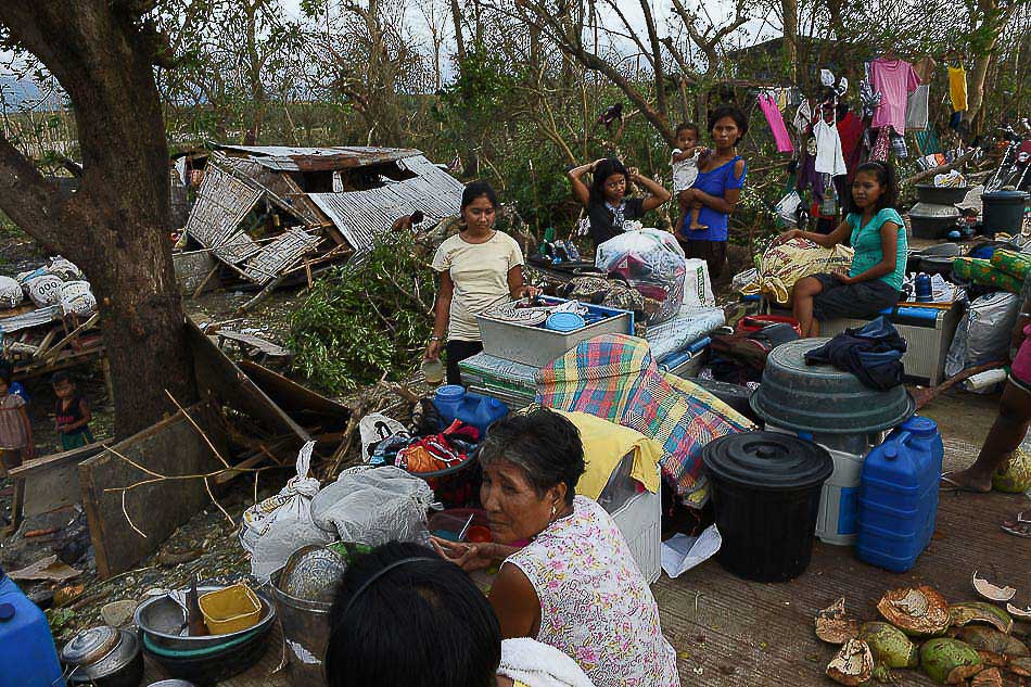 Residents gather their belongings along a highway after their house was destroyed by super typhoon Lawin in San Pablo town, Isabela province on Thursday. Photo: Ted Aljibe/AFP