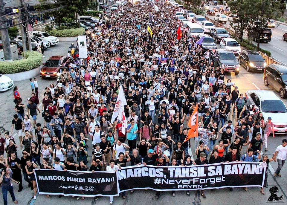 Students from the University of the Philippines, Ateneo De Manila, Miriam College march together along Katipunan Avenue after a joint campus walkout was held in protest of Marcos' burial last November 18. Photo: Campaign Against the Return of the Marcoses to Malacañang - Carmma