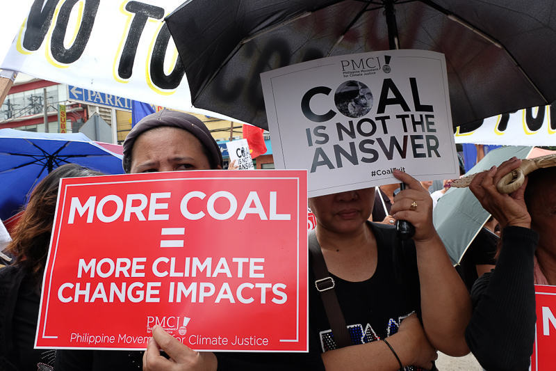 Climate activists dressed as "coal spectres" to symbolize the menace of dirty energy during their peaceful protest at an international coal industry summit in the Philippines today, November 18, 2016 in front of New World Hotel and Dusit Thani. Photo: AC Dimatatac 