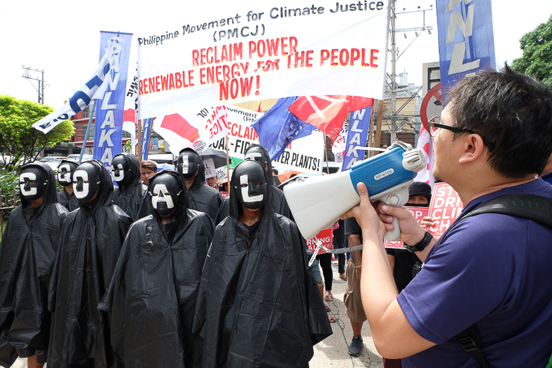Climate activists dressed as "coal spectres" to symbolize the menace of dirty energy during their peaceful protest at an international coal industry summit in the Philippines today, November 18, 2016 in front of New World Hotel and Dusit Thani. Photo: AC Dimatatac 