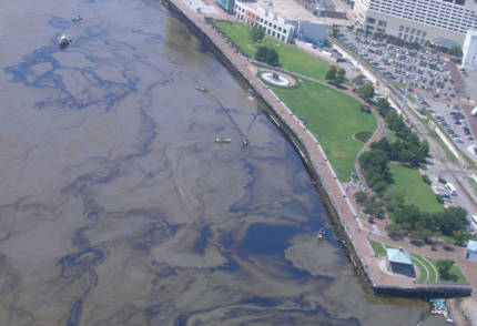 Boats cleaning up an oil spill.